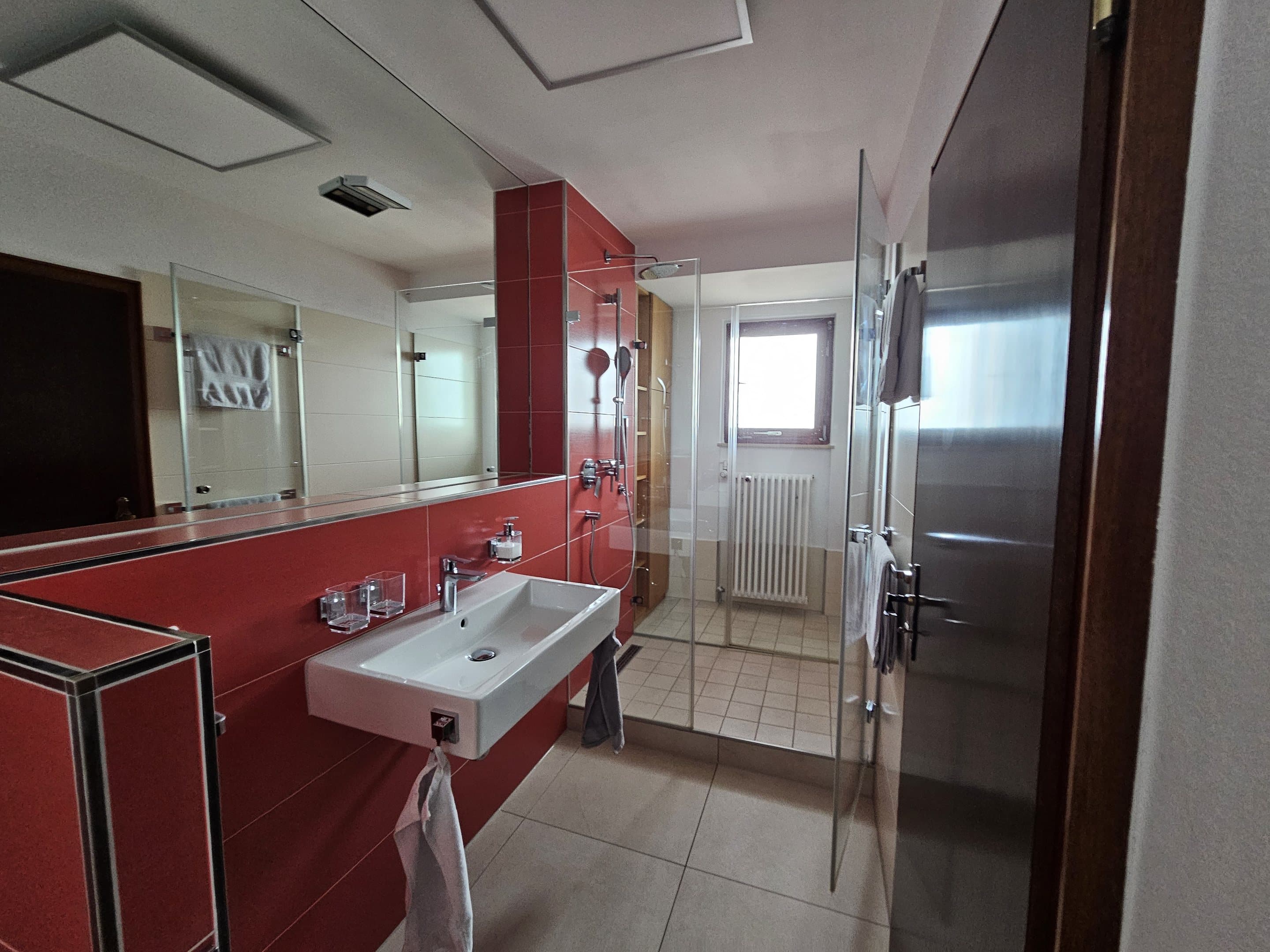 Badezimmer der Ferienwohnung mit Regendusche und modernem Waschbereich